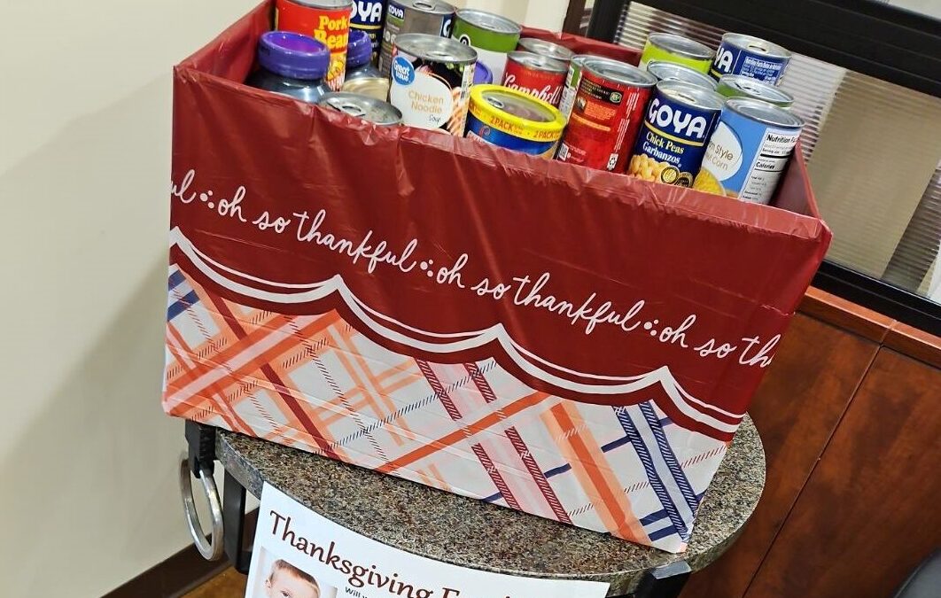 A table set up to remind people to donate for the food drive.